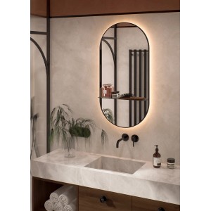 Owalne lustro LED w łazience z umywalką i dekoracją.