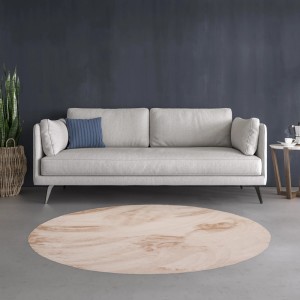 Beżowy, okrągły dywan shaggy t.b.t. w salonie z sofą.