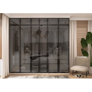 Nowoczesna szafa t.b.t. z ciemnymi szklanymi drzwiami do sypialni lub garderoby.