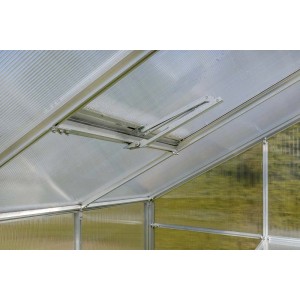 Zbliżenie automatycznego otwieracza okien w szklarni.