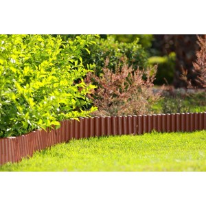 Brązowe obrzeże trawnikowe t.b.t. z tworzywa sztucznego w ogrodzie.