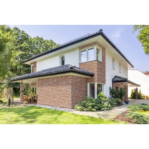 Fasada domu z cegłami licowymi t.b.t. w kolorze czerwono-brązowym. Dekoracyjne Kamienie i klinkier do użytku zewnętrznego.