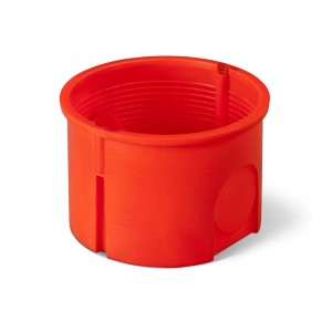 Pomarańczowa puszka podtynkowa do instalacji elektrycznej.