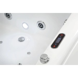Zbliżenie białej wanny z hydromasażem t.b.t. z dyszami i elementami sterującymi.