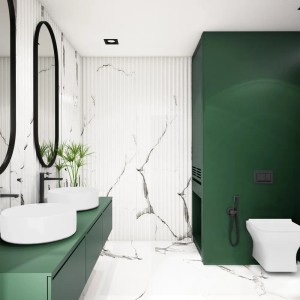 Nowoczesna łazienka z bidetką, umywalkami i lustrami na tle zielonej ściany.