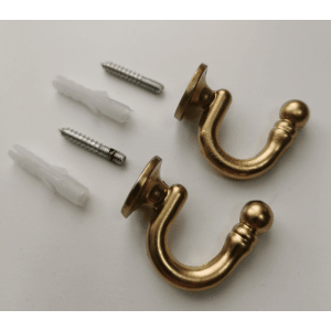 Złote haczyki do zasłon ze śrubami do mocowania do karniszy.