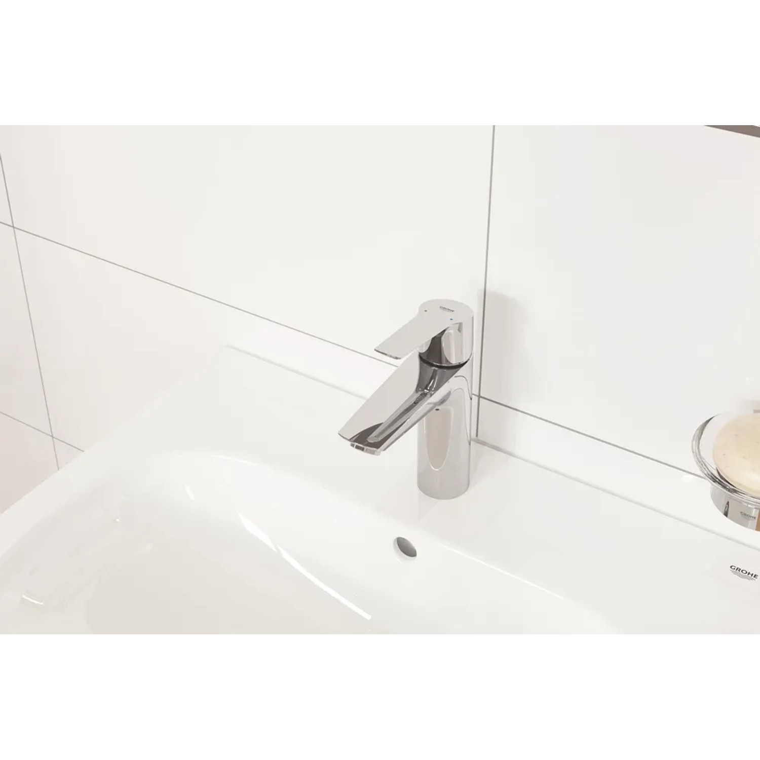 Bateria umywalkowa Grohe QuickFix Start S-Size z zestawem odpływowym Push-open na białej umywalce.