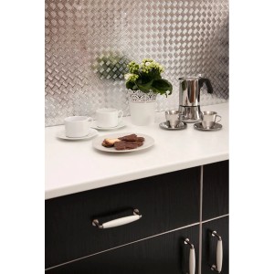 Srebrna folia t.b.t. jako dekoracja kuchenna z zestawem do kawy i ciastkami na białym blacie.