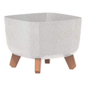 Kwadratowa, biała doniczka z brązowymi nóżkami.