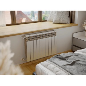 Grzejnik t.b.t. pod parapetem w sypialni.