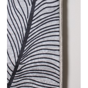 Zbliżenie szarego dywanu z krótkim włosiem i abstrakcyjnym wzorem liścia.