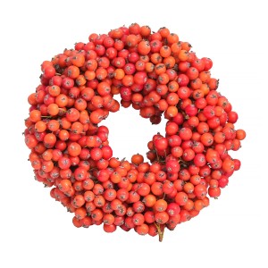 Dekoracyjny wieniec z czerwonych jagód, idealny jako roślina doniczkowa lub dekoracja stołu.