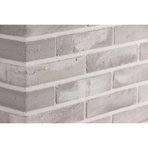 Szare płytki dekoracyjne t.b.t. jako okładzina ścienna.