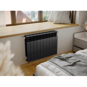Czarny grzejnik t.b.t. pod oknem w nowoczesnej sypialni.