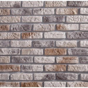 Dekoracyjna ściana z klinkieru t.b.t. w odcieniach szarości, beżu i brązu.