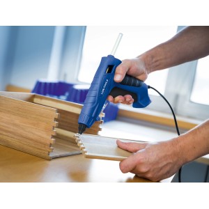 Użycie niebieskiego pistoletu do kleju na gorąco LUX z przezroczystymi wkładami do klejenia drewna.