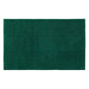 Zielony dywanik łazienkowy z wypustkami.