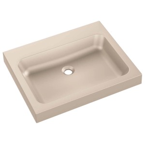 Beżowa umywalka nablatowa.