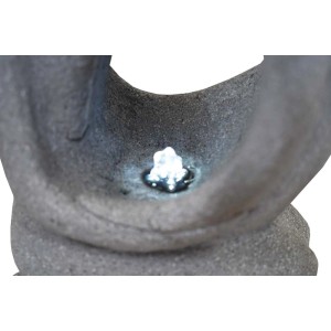 Zbliżenie szarej fontanny ogrodowej z oświetleniem LED.