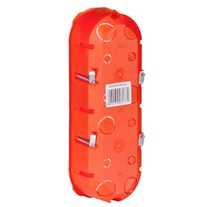 Pomarańczowa puszka podtynkowa t.b.t. z wycięciami i metalowymi klipsami.