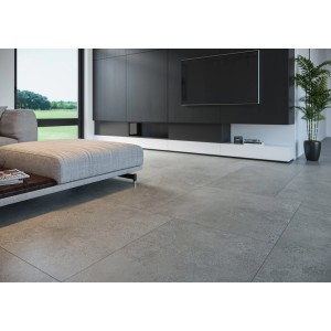 Szare płytki podłogowe t.b.t. ułożone w nowoczesnym salonie.