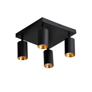 Czarny spot z czterema cylindrycznymi lampami i złotymi reflektorami.