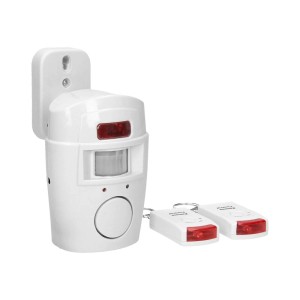 Biały czujnik ruchu z dwoma pilotami do systemów alarmowych.