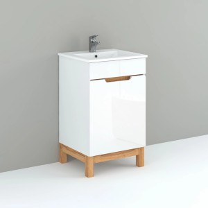 Biała szafka pod umywalkę z drewnianymi nogami i umywalką do łazienki.