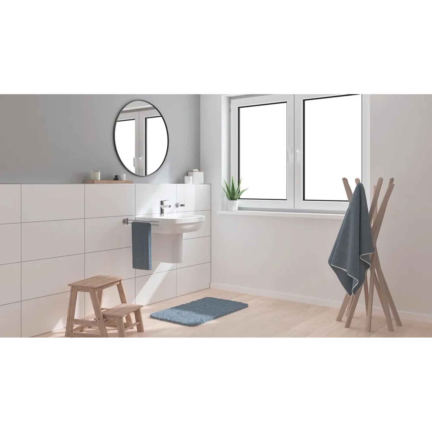 Bateria umywalkowa Grohe QuickFix Start w nowoczesnej łazience z umywalką i ręcznikiem.
