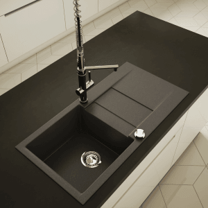 Czarny zlewozmywak granitowy z ociekaczem i baterią na blacie kuchennym.