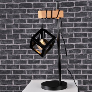 Nowoczesna lampa stołowa z czarnym kloszem w kształcie kostki i elementem drewnianym.