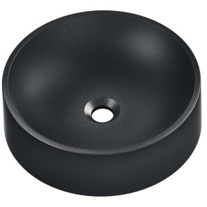 Czarna umywalka nablatowa t.b.t., okrągły kształt.