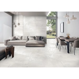 Jasny salon z płytkami podłogowymi t.b.t. o wyglądzie betonu. Nowoczesny design z sofą i stołem jadalnym.