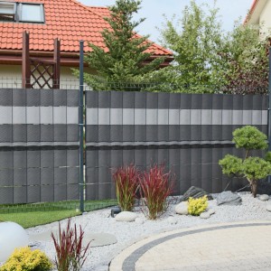Szara mata ogrodzeniowa t.b.t. na ogrodzeniu w ogrodzie.