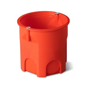 Pomarańczowa puszka podtynkowa do instalacji elektrycznych.