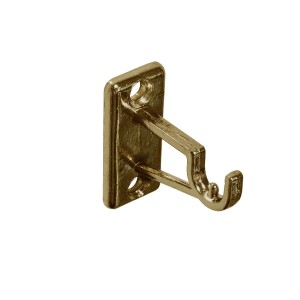 Złoty wspornik do montażu karnisza na ścianie.