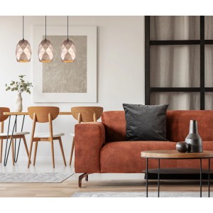 Trzy nowoczesne lampy wiszące t.b.t. nad stołem w jadalni w salonie.