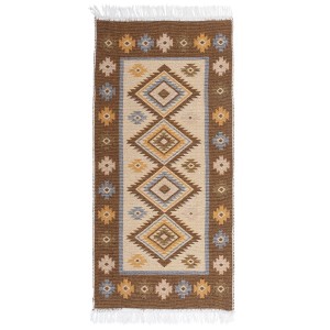 Wzorzysty dywan z krótkim włosiem i frędzlami w odcieniach brązu, beżu i błękitu.