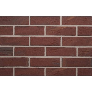 Zbliżenie na czerwone płytki klinkierowe t.b.t. imitujące mur.