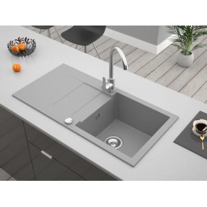 Szary zlewozmywak granitowy t.b.t. z ociekaczem i baterią na blacie kuchennym.