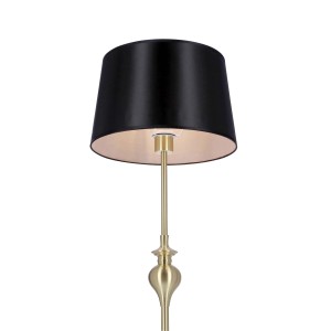 Elegancka lampa podłogowa z czarnym abażurem i złotą ramą do nastrojowego oświetlenia.