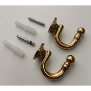 Złote haczyki do zasłon ze śrubami i kołkami do karniszy.