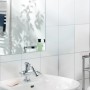 Taśma montażowa LUX w łazience: Lustro, umywalka i bateria na białej ścianie z płytek.